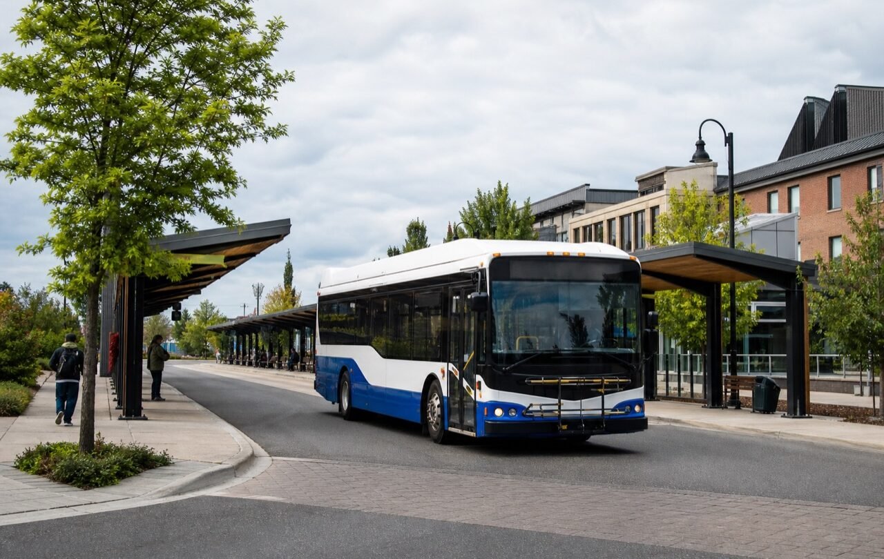Original development image of an unbranded municipal bus at a fictional transit exchange.