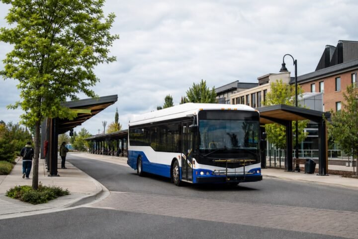 Original development image of an unbranded municipal bus at a fictional transit exchange.